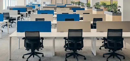 Modern open-plan office space featuring clean workstations, ergonomic chairs, and sanitized carpets provided by professional office cleaning services in Tuscaloosa, AL.