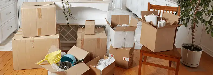 Packed moving boxes and household items in a kitchen before move-out or move-in cleaning, Tuscaloosa, AL.